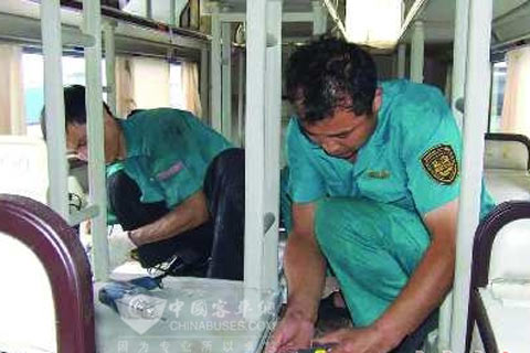 工人们正在为青岛交运的卧铺客车加宽逃生通道